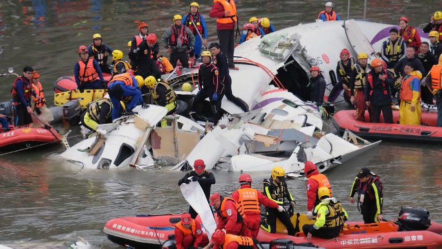 Des équipes de secours tentent de dégager des passagers survivants du crash d'un ATR 72-600 de la TransAsia Airways dans une rivière, le 4 février 2015 près de Taipei