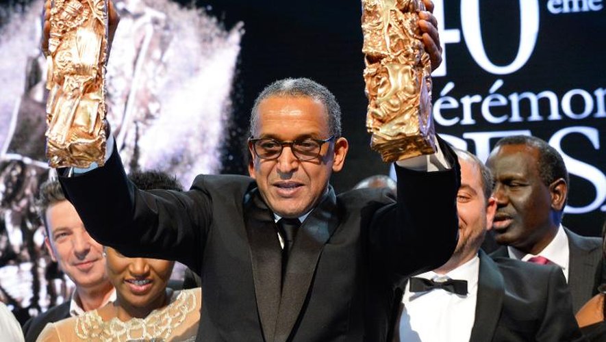 Abderrahmane Sissako brandit ses trophées lors de la cérémonie des César le 20 février 2015 à Paris