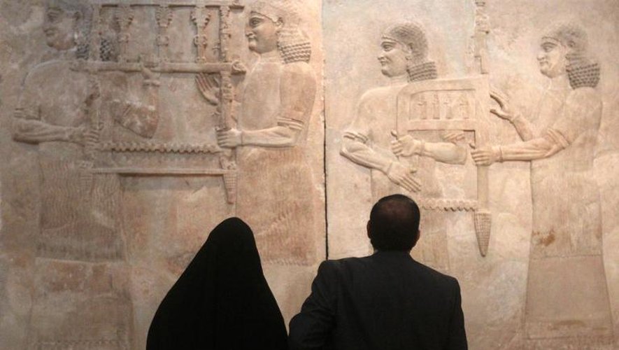 Des visiteurs admirent un bas-relief assyrien au Musée national irakien de Bagdad, le 1er mars 2015