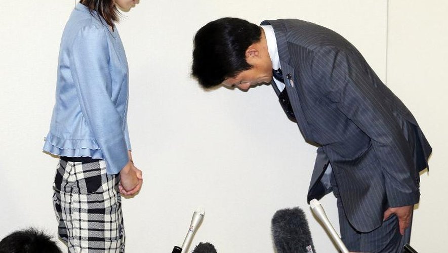 Akihiro Suzuki (d), un élu du parti au pouvoir au Japon, présente ses excuses le 23 juin 2014 à Ayaka Shiomura, pour les propos sexistes qu'il a tenus à son égard à l'Assemblée législative de Tokyo.