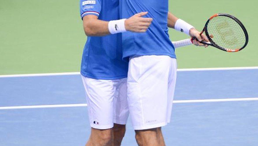 Nicolas Mahut (g) dans les bras de Julien Benneteau après le double remporté contre l'Allemagne en Coupe Davis, le 7 mars 2015 à Francfort