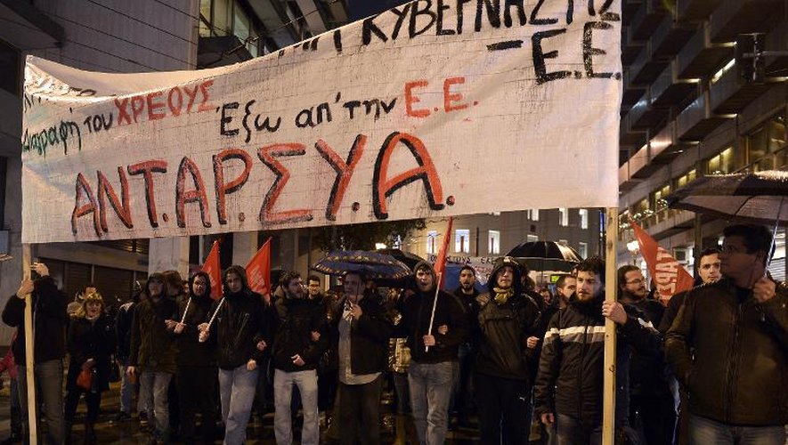 Des manifestants avec des banderoles demandant l'annulation de la dette grecque et la sortie de la Grèce de la zone euro, le 26 février 2015 à Athènes
