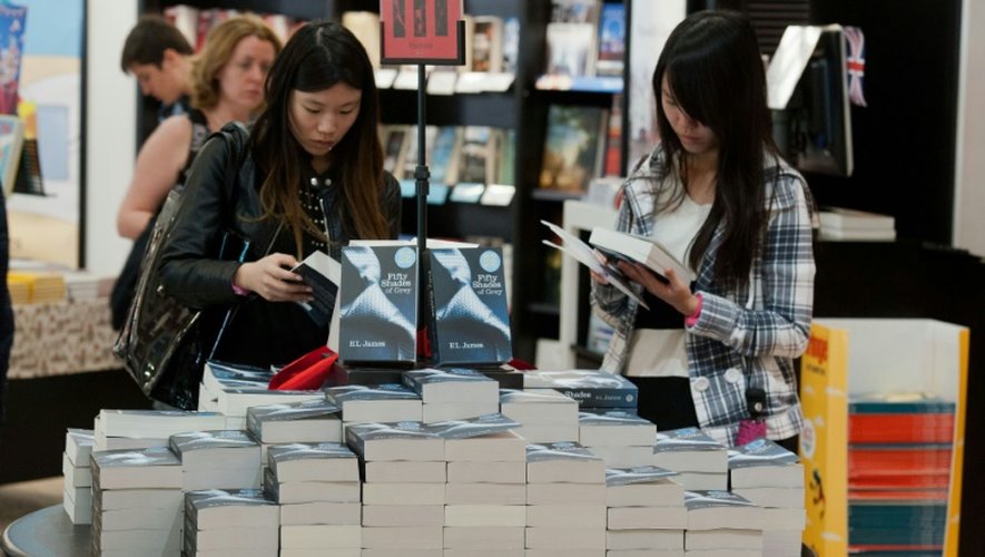 Des jeunes femmes regardent le livre "Cinquante nuances de Grey" le 19 juillet 2012  à Londres