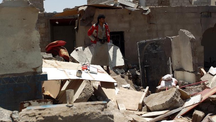 Un Yéménite regarde sa maison en ruines, détruite par un raid aérien, près de l'aéroport de Sanaa le 31 mars 2015