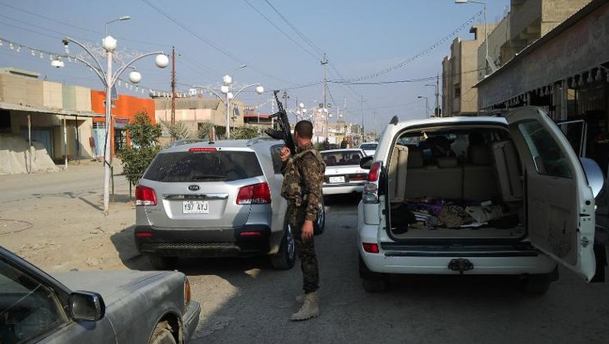 Un soldat irakien surveille les véhicules à un point de contrôle, le 2 janvier 2014 à Ramadi