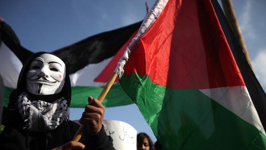 Un Palestinien porte un masque du mouvement anonymous lors d'une manifestation du devant l'Organisation de libération de la Palestine à Ramallah le 4 janvier 2014