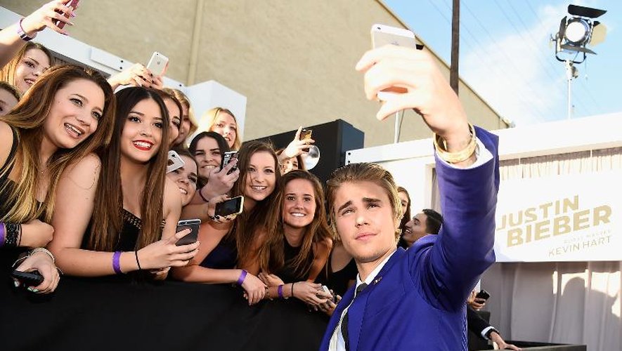 Justin Bieber se prend en selfie avec des fans le 14 mars 2015 à Los Angeles, Etats-Unis