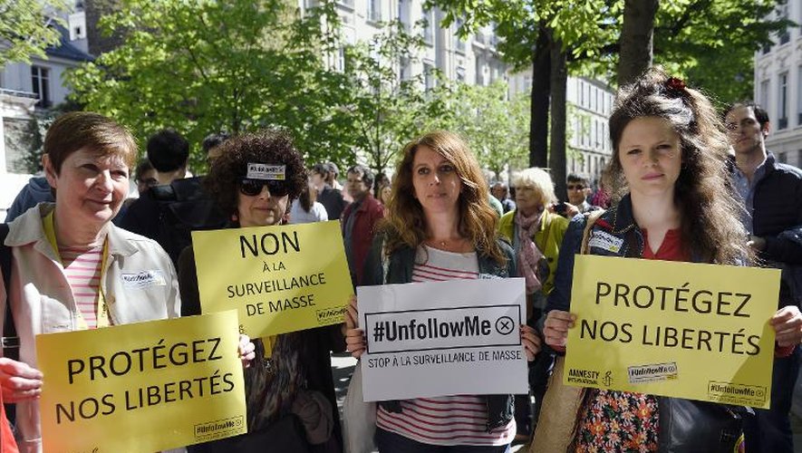Des manifestants protestent dans les rues de Paris contre le projet de loi sur le renseignement, le 13 avril 2015