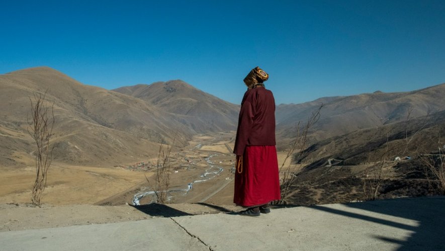 Une moniale bouddhiste tibétaine regarde la vallée de Sertar, en Chine, le 8 décembre 2015