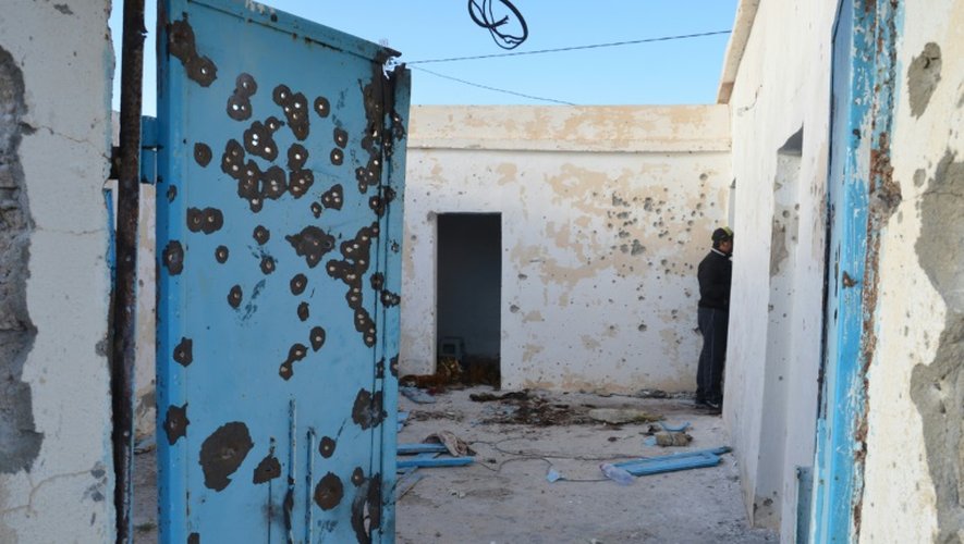 Un homme inspecte une  maison à Benniri, au sud de la ville tunisienne de Ben Guerdane théâtre d'accrochages entre jihadistes et militaires, le 9 mars 2016