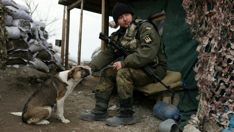 Un soldat ukrainien et un chien recueilli près de Sartana, dans l'est de l'Ukraine, le 29 février 2016