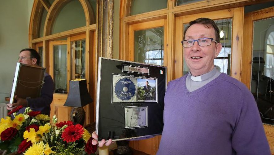 Le père irlandais Ray Kelly montre le 19 avril 2015 dans sa maison de Oldcastle, dans le nord de l'Irlande, une copie encadrée du disque de platine obtenu avec son album "Where I Belong"