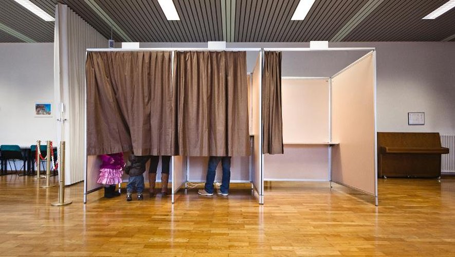 Une famille remplit ses bulletins de vote le Ascona le 9 février 2014
