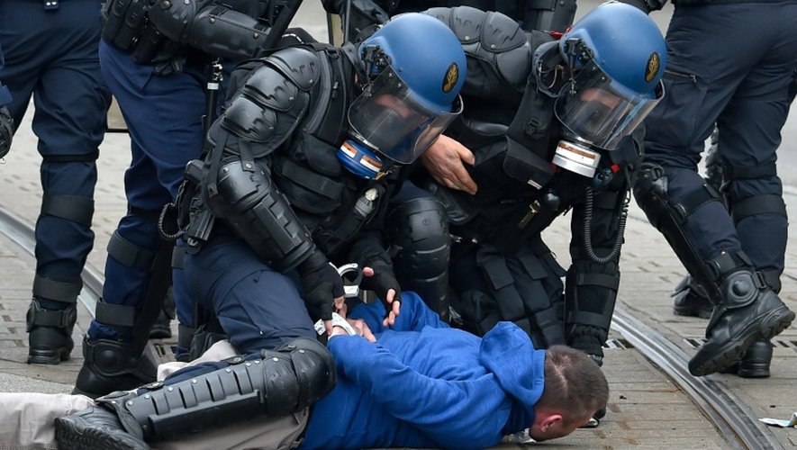 Des policiers anti-émeute arrêtent un manifestant contre la réforme du travail à Nantes le 24 mars 2016