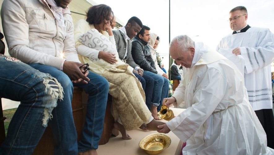 Photo fournie par les services de presse du  Vatican montrant le pape François accomplissant le rituel du lavement des pieds au centre d'accueil pour migrants à Castelnuovo di Porto, près de Rome, le 24 mars 2016