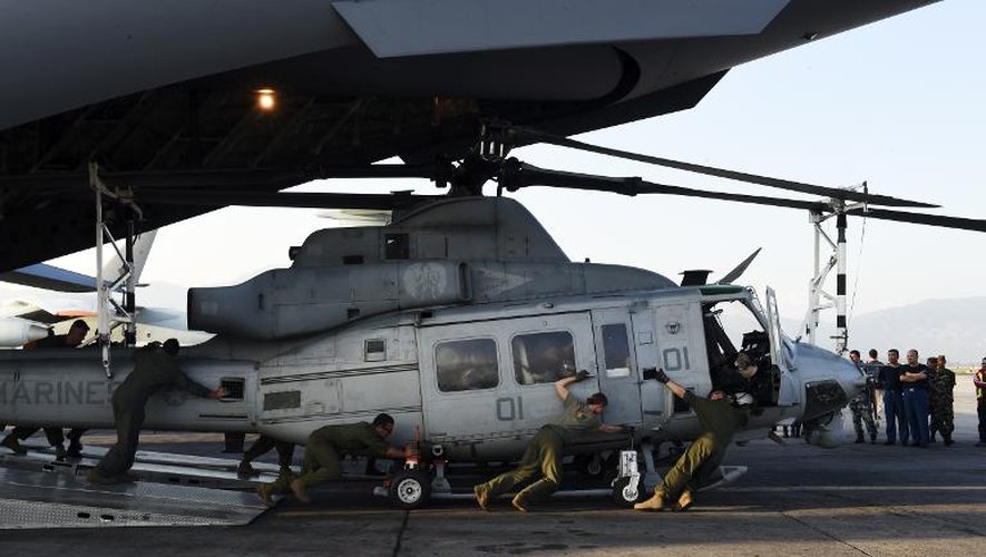 Des militaires américains sortent un hélicoptère  Huey d'un avion de transport, le 3 mai 2015 à l'aéroport international de Katmandou