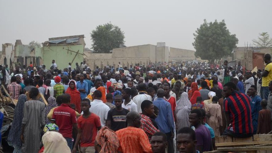 La foule afflue sur le lieu des deux explosions qui ont secoué la ville de Maiduguri, dans le nord-est du Nigeria, le 2 mars 2014