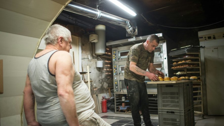 Michel Flamant (g) et Jérôme Aucant travaillent dans leur boulangerie, le 23 mars 2016 à Dole, dans le Jura