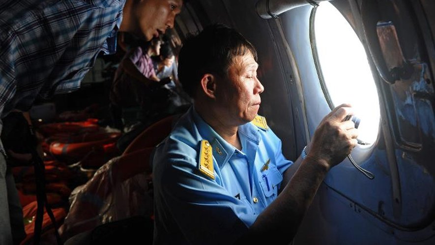 Un officier vietnamien effectue des repérages aériens pour trouver des traces du Boeing disparu de Malaysia Airlines le 9 mars 2014