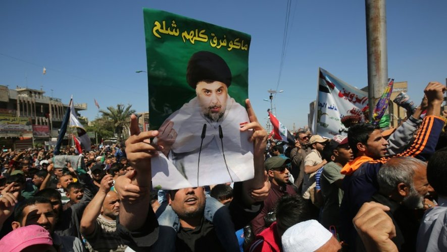 Des partisans du chef chiite irakien Moqtada Sadr brandissent son portrait, lors d'une manifestation anticorruption à Bagdad le 1er avril 2016