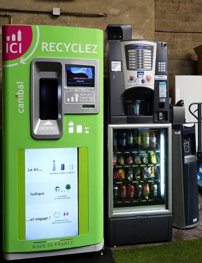 Une machine qui recycle les gobelets en plastique à côté d'un distributeur de café le 22 mai 2015 au siège de la compagnie Canibal à Gennevilliers
