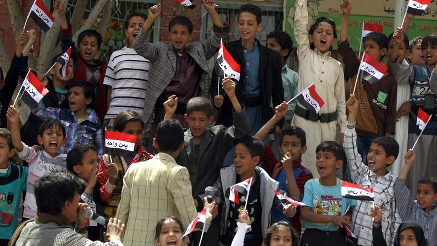 Des enfants yéménites brandissent le drapeau national lors d'une manifestation contre les opérations armées de l'Arabie saoudite le 6 juin 2015 à Sanaa