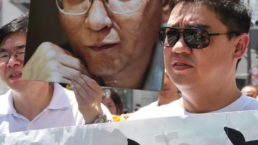 Le dissident chinois  Wu'er Kaixi devant une photo de Liu Xiaobo lors d'une manifestation le 1er juin 2014 à Tokyo