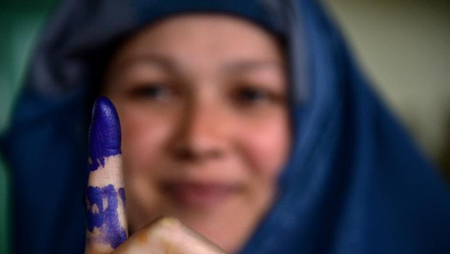 Une électrice afghane montre son doigt marqué à l'encre, après avoir voté, à Kaboul le 5 avril 2014