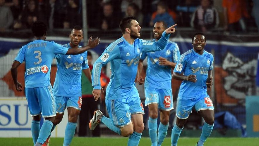 Les joueurs de Marseille exultent après le but d'André-Pierre Gignac (c) contre Montpellier en Ligue 1, le 11 avril 2014 au stade de la Mosson
