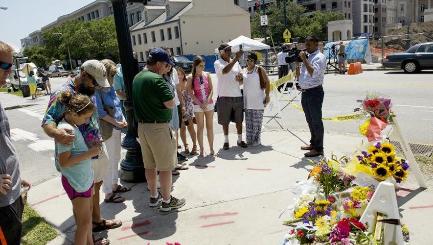 Des passants déposent des fleurs près de l'église noire où s'est produit le massacre, le 18 juin 2015 à Charleston, Caroline du sud, dans le sud-est des Etats-Unis
