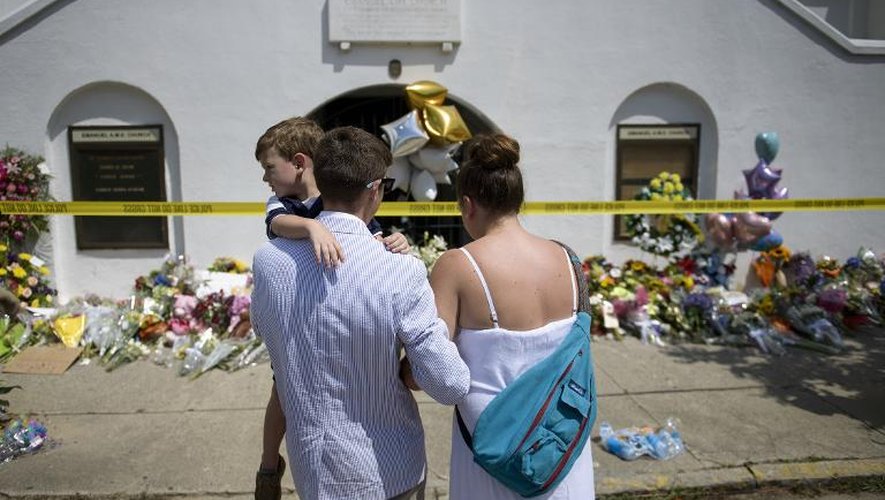 Une famille vient se recueillir devant l'église Emanuel, le 19 juin 2015 à Charleston