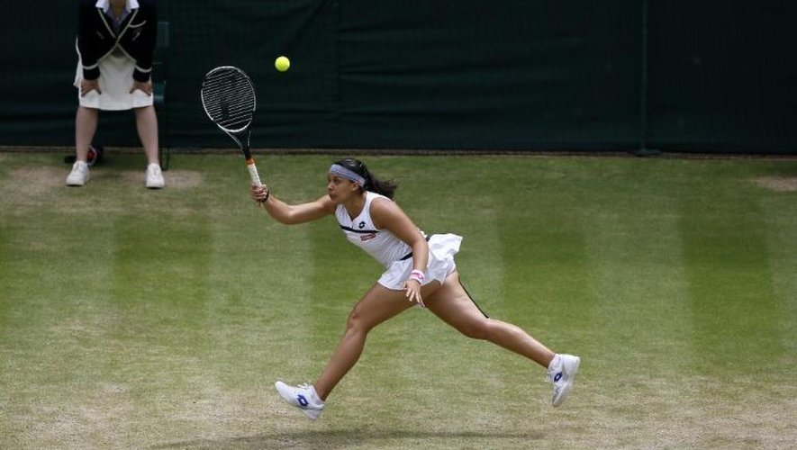 Marion Bartoli pendant sa demi-finale victorieuse contre Kirsten Flipkens au tournoi de Wimbledon le 4 juillet 2013 à Londres