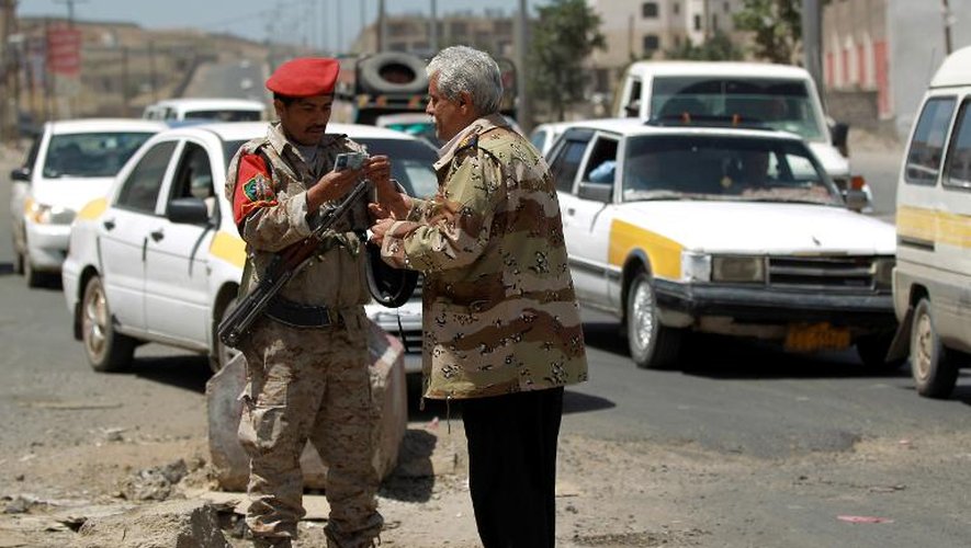 Un soldat yéménite vérifie l'identité d'un homme à un checkpoint à Sanaa le 15 avril 2014