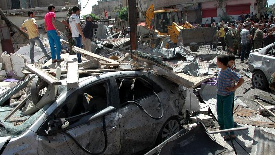 A Homs, les équipes de secours sur les lieux de l'explosion d'une voiture piégée qui a fait au moins 45 morts et 80 blessés, le 29 avril 2014
