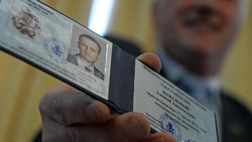 Le président de la Commission électorale de Moscou tient la carte certifiant qu'Alexeï Navalny est candidat à l'élection du maire de la capitale russe, le 17 juillet 2013