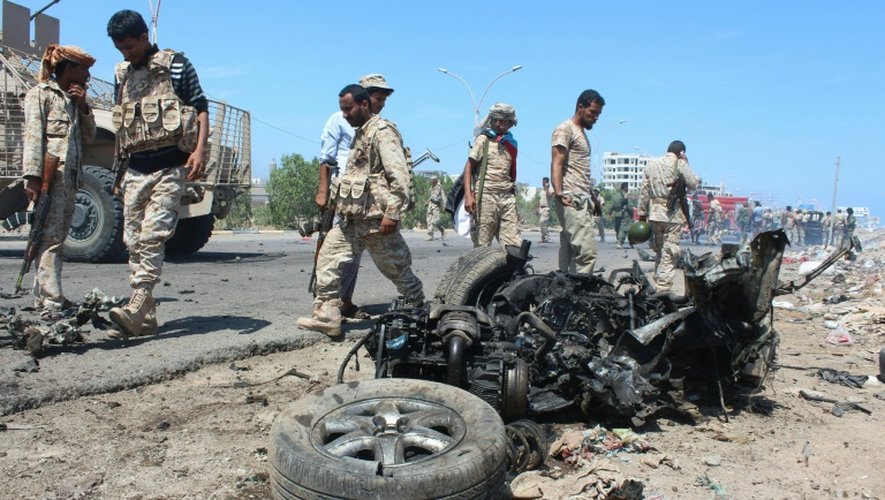 Les forces de sécurité yéménites inspectent le lieu de l'explosion d'une voiture piégée à Aden le 1er mai 2016