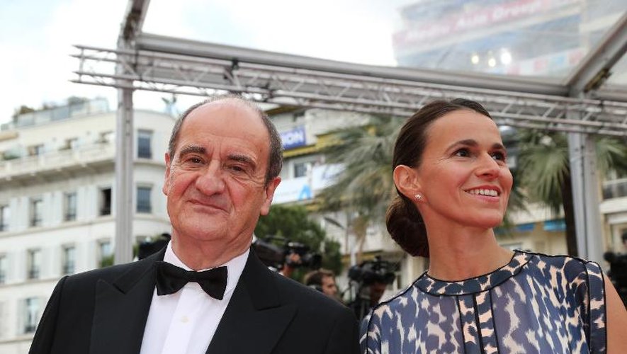 Le prochain président du festival de Cannes, Pierre Lescure, en smoking comme il se doit, lors de la cérémonie d'ouverture du 67e festival de Cannes, au bras de la ministre de la Culture Aurélie Filippetti, le 14 mai 2014