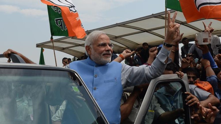Narendra Modi fait le signe de la victoire à son arrivée à l'aéroport Indira Ghandi à New Delhi le 17 mai 2014