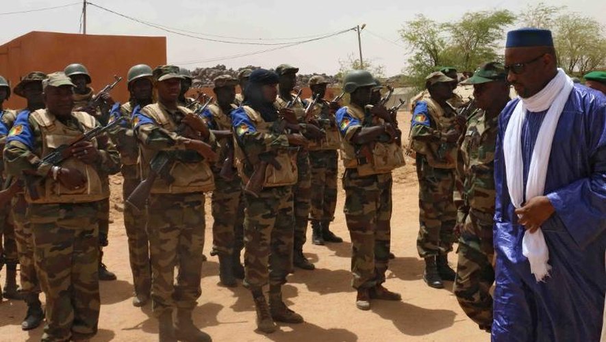 Le Premier ministre malien Moussa Mara (d) passe les troupes en revue à son arrivée à Kidal, au nord du Mali, le 17 mai 2014