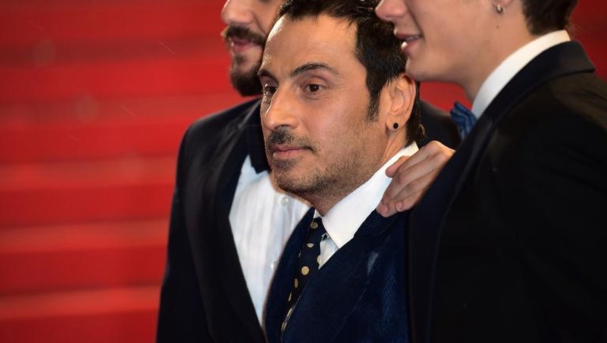 Le réalisateur grec Panos Koutras (centre) avec les acteurs Costas Nicouli et Nicos gelia pour la présentation du film "Xenia" au festival de Cannes, le 19 mars 2014