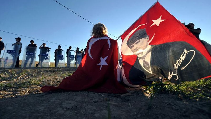 Un manifestant enroulé dans un drapeau à l'effigie de Mustafa Kemal Atatürk, sur la route du tribunal de Silivri, près d'Instanbul, le 5 août 2013