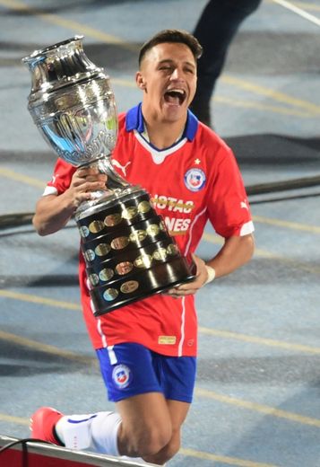 L'attaquant Alexis Sanchez célèbre, trophée en mains, la victoire du Chili en finale de la Copa America, le 4 juillet 2015 à Santigao