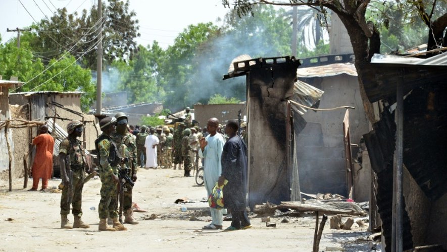 Des soldats parlent avec des habitants de Zabarmari, un village proche de Maiduguri victime d'une attaque de Boko Haram, le 3 juillet 2015