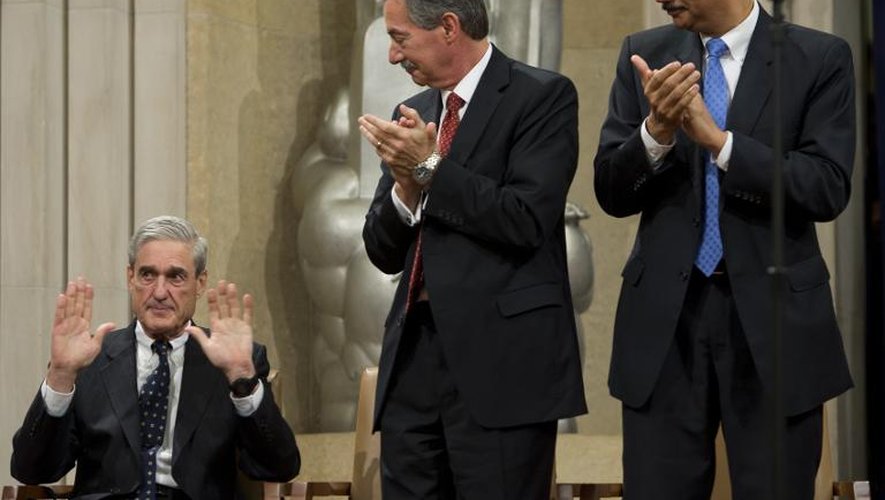 Robert Mueller, le patron du FBI (assis), le 1er août 2013 à Washington lors d'une cérémonie de départ