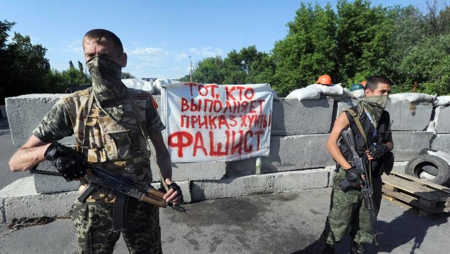"Ceux qui exécutent les ordres de la junte sont fascistes" peut-on lire sur une barricade gardée par des activistes pro-russes armés le 6 juin 2014 à Slaviansk