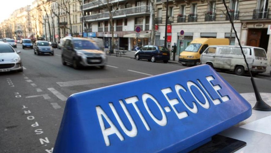 Une voiture d'auto-école circulant dans une rue de Paris