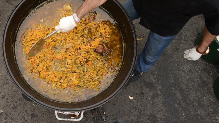 Un homme cuisine une soupe asiatique pendant un festival de "street food" dans le centre de Moscou, le 31 août