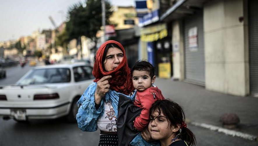 Une réfugiée syrienne avec ses enfants dans une rue d'Istanbul, le 19 juin 2014