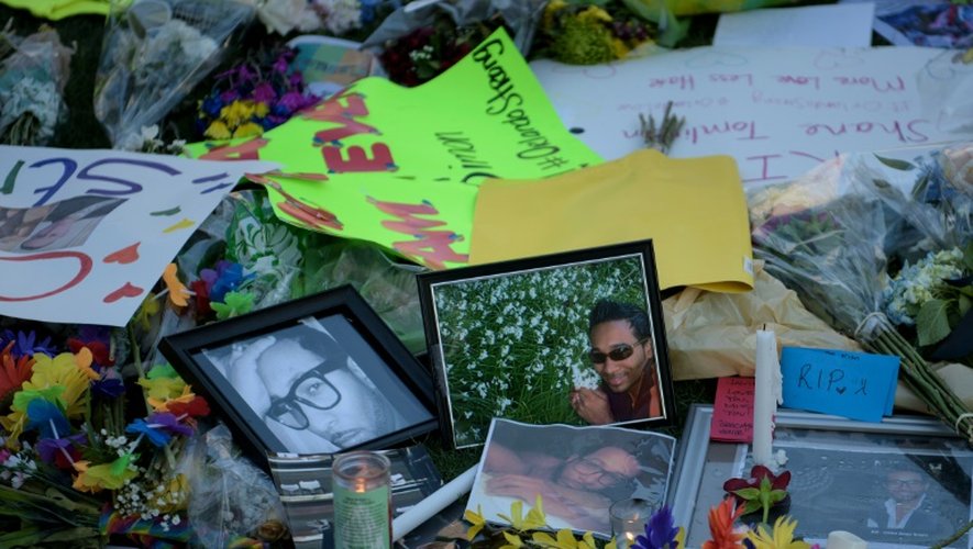 Des photos et des fleurs dispersés devant le mémorial pour les victimes du Pulse à Orlando le 14 juin 2016