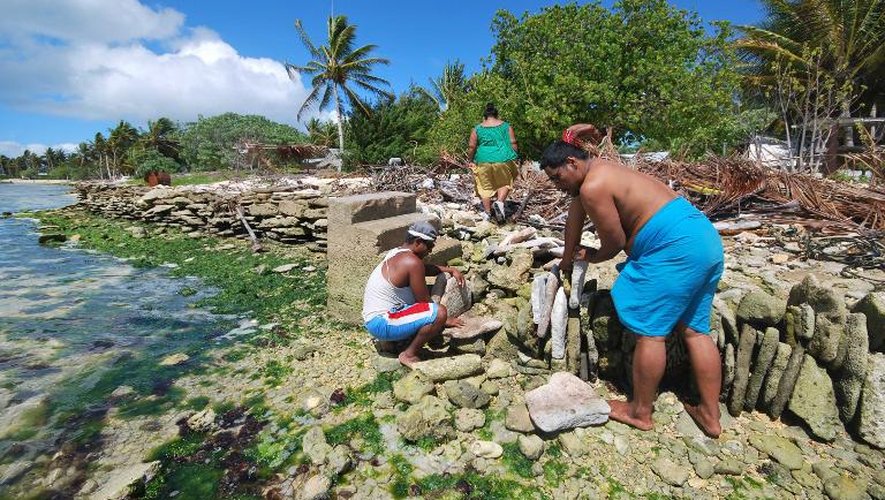 Des habitants des îles Kiribati contruisent une digue pour se protéger de la hausse du niveau de la mer